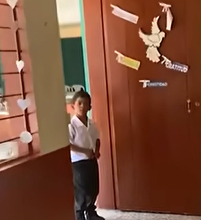 8-yr-old boy opens the classroom door and bursts into tears