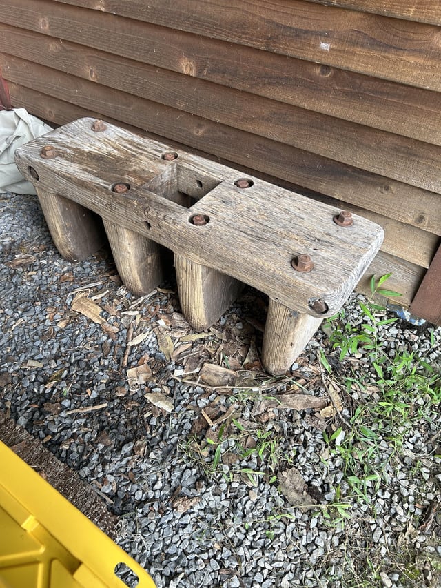 Wooden bench with a hole in the middle. The bolts go all the way through the legs and it is very heavy. Found in the basement of an old farm house